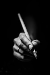 The artist's hands hold a brush