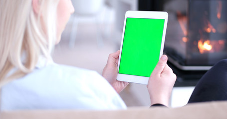 woman on sofa using tablet computer