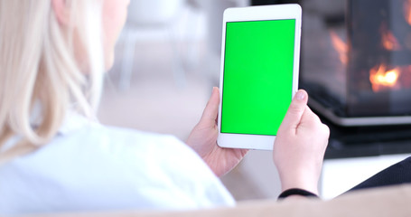 woman on sofa using tablet computer