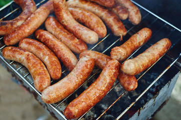 sausages of meat cooking on the grill .Barbecue on the nature