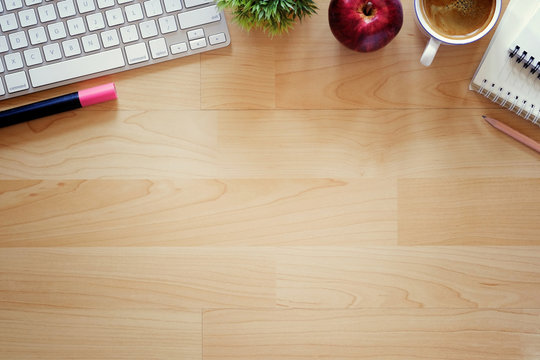 Office desktop with office accessories, Wood table with business objects and snack foods. Copy space for text or products display montage.