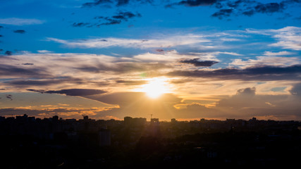 city skyline at dawn, the outlines of houses in the backlight,