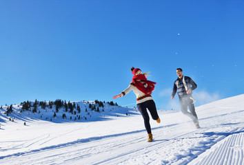 Cheerful young couple having fun in winter park