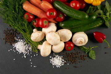 Close-up of a fresh delicious ingredients for healthy cooking or salad making on rustic background, top view, banner. Diet or vegetarian food concept.