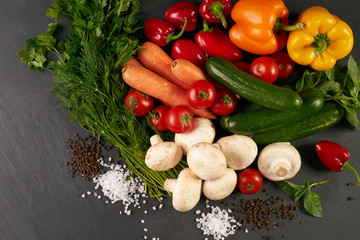 Top view of a raw vegetables. View from above of a Fresh vegetable. Colorful vegetables background. Healthy vegetable studio photo. Assortment of fresh vegetables on dark stone kitchen table.
