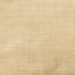 Hessian sack cloth texture canvas fabric pattern background in light yellow cream brown color