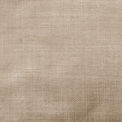 Hessian sack cloth texture canvas fabric pattern background in light aged sepia cream brown color