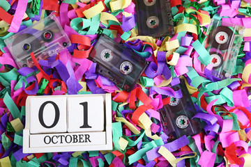 Old cassette tapes with wooden cubes on colourful confetti
