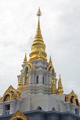 Fototapeta premium Top of thai temple in cloudy sky