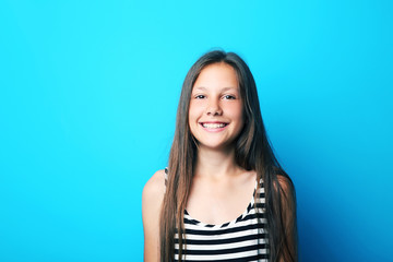 Fototapeta premium Portrait of beautiful girl on blue background