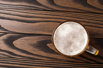Mug of beer on an old wooden table