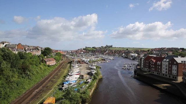 Whitby North Yorkshire England uk seaside town and tourist destination in summer with view of River Esk to Abbey and coast