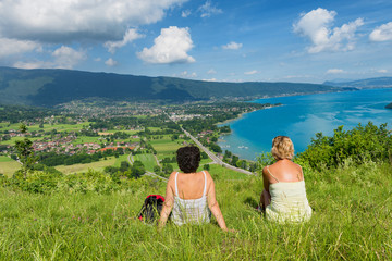 Two women watching  view of Lake Annecy