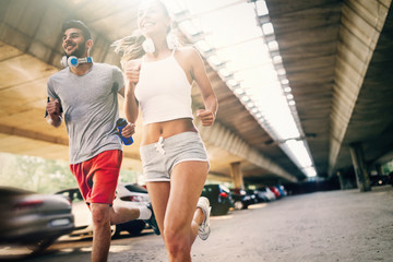 Obraz na płótnie Canvas Attractive man and beautiful woman jogging together