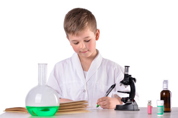 Fototapeta na wymiar Scientist boy in the chemistry lab write with a pen