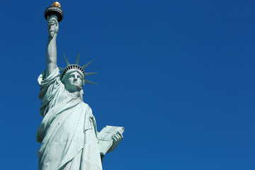 Fototapeta premium Statue of Liberty, blank blue sky space in New York