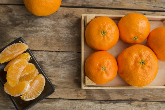Mandarin Oranges - mandarin oranges on a rustic wooden board.
