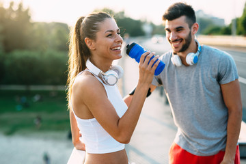 Portrait of man and woman during break of jogging