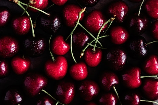 Creative fruit print pattern background with dark cherries 