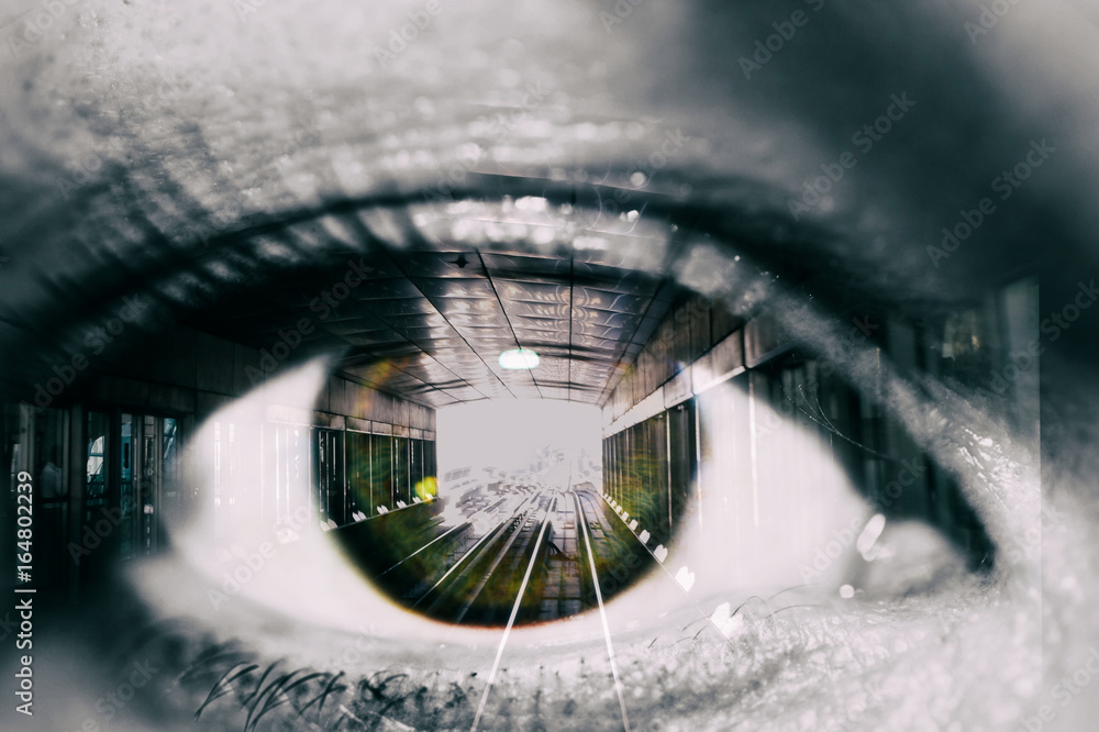 Wall mural double exposure of the female eye and tunnel with train car in subway