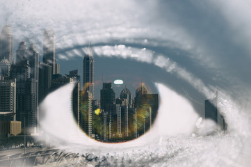 Double exposure of the female eye and the city of Dubai