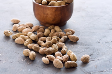 Wooden bowl with unpeeled nuts Nuts Almond peanuts Healthy snack