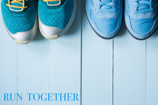 two pairs of running sneakers on blue background