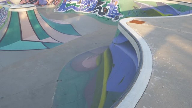 Skateboarder doing tricks on Concrete Skatepark Ramp - Slow Motion