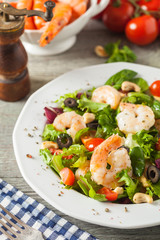 Shrimp salad with tomato, olives and cashew nuts.