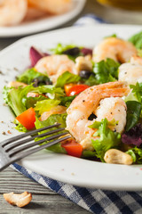 Shrimp salad with tomato, olives and cashew nuts.