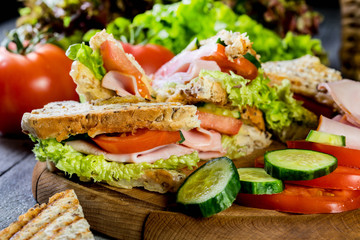 Panini sandwich with ham, tomato and lettuce.