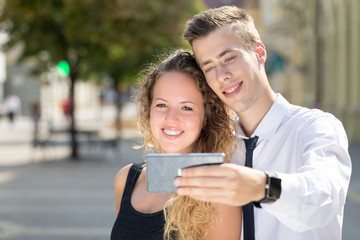 young couple selfy on street