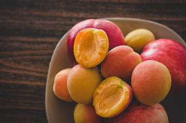 Sweet delicious apricots and nectarines served on wooden table