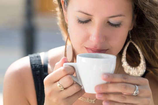 young woman portrait , drinking coffee in cafe outdoor in summer