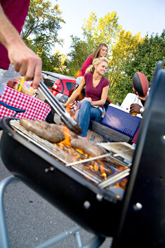Tailgating: Focus On Girl With Food Cooking In Foreground