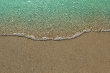 wave on sand beach with copy space,concept for beach background.