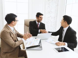 Happy businessman team meeting at modern office and shaking hand with business partners.