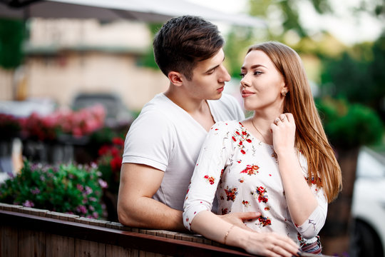 Portrait of young modern couple in love, posing outdoors in city street