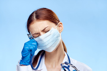 Young beautiful woman on a blue background, medicine, doctor