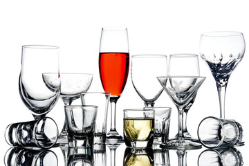 Collage of empty glasses with alcohol on white background.