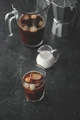 Glass of cold brew coffee on dark table
