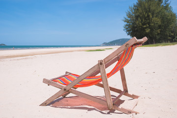 Red canvas chair on the beach.