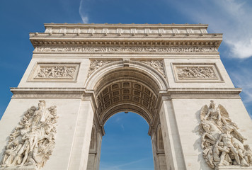 Fototapeta na wymiar Arc de Triomphe in Paris under sky with clouds