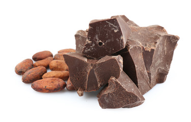 Pile of dark chocolate chunks and cocoa beans on white background