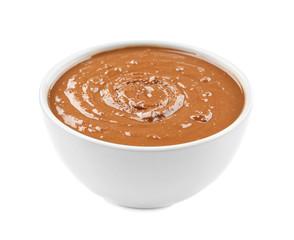 Peanut butter in ceramic bowl on white background