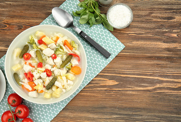 Plate with turkey soup on wooden table