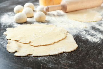 Fototapeta na wymiar Unleavened dough for tortillas on kitchen table