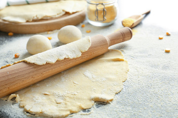 Fototapeta na wymiar Unleavened dough for tortillas with rolling pin on kitchen table