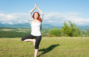 Beautiful woman in tree yoga position