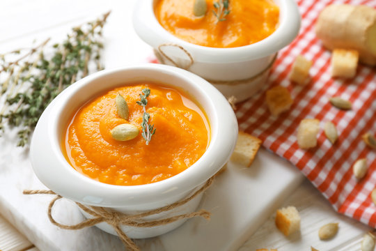 Delicious carrot soup on table